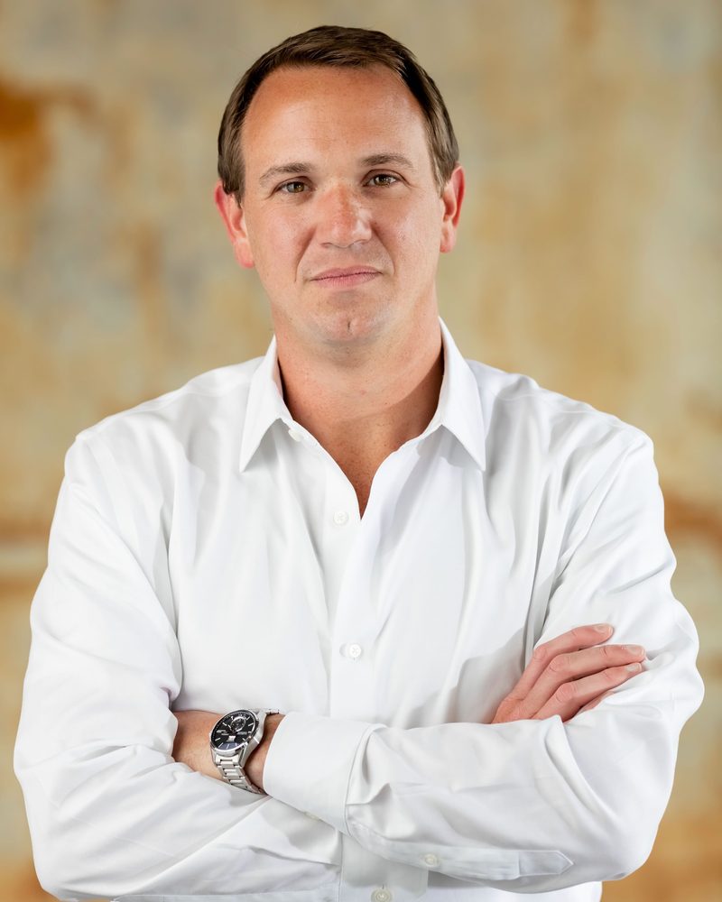 Brian Onorio in a white shirt, arms crossed